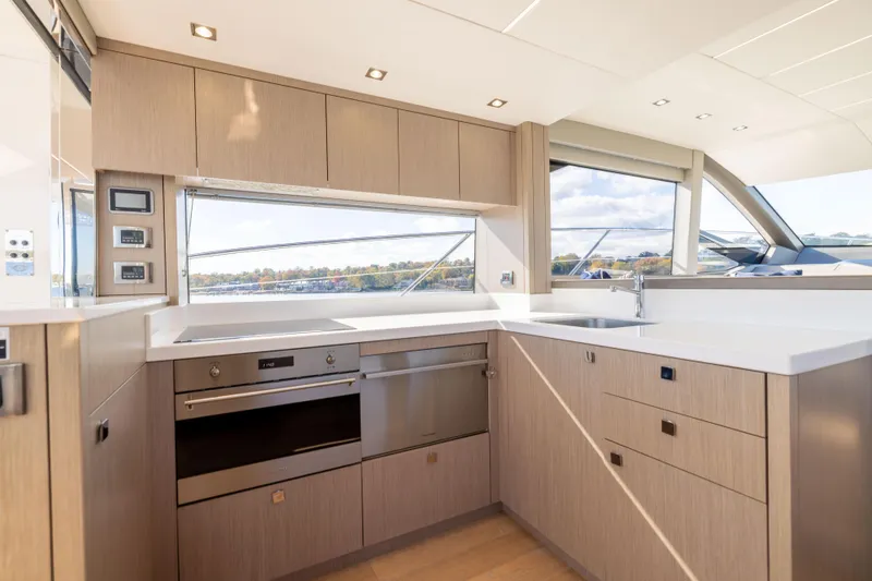 Slide: The Image of Modern kitchen interior on 2018 Sunseeker Manhattan 52 yacht, featuring sleek cabinetry and appliances. - 22