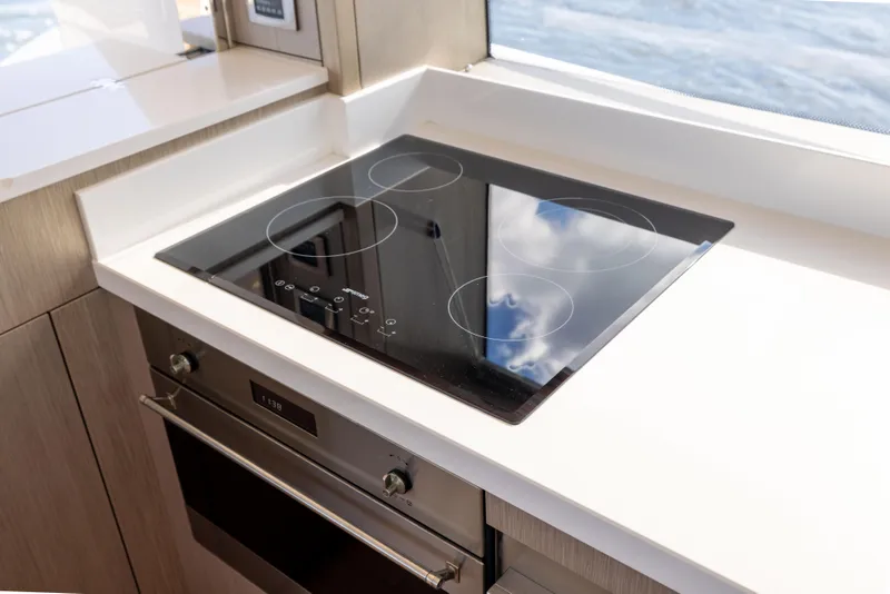 Slide: The Image of Modern kitchen on 2018 Sunseeker Manhattan 52 yacht with sleek stovetop and oven. - 26