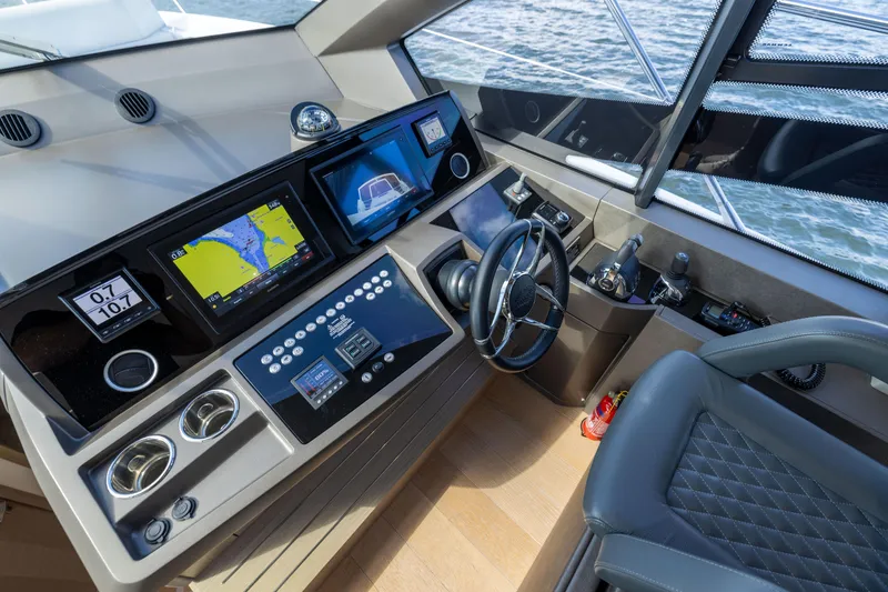 Slide: The Image of Cockpit of 2018 Sunseeker Manhattan 52 yacht with navigation screens and controls. - 38