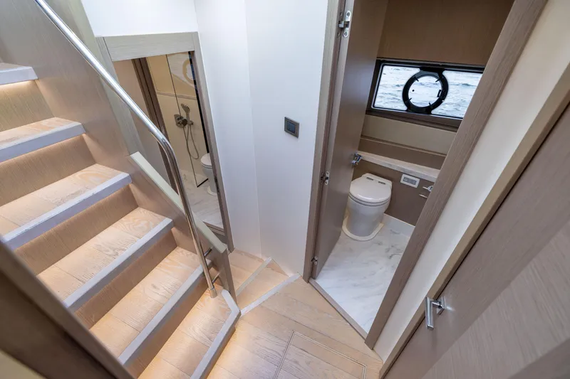 Slide: The Image of 2018 Sunseeker Manhattan 52 yacht interior with stairs and bathroom view. - 50