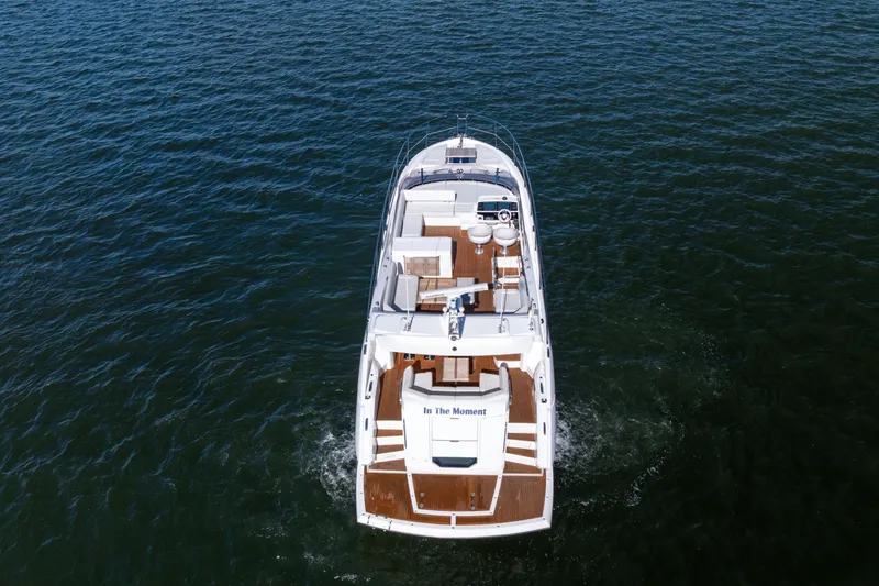 Slide: The Image of 2018 Sunseeker Manhattan 52 yacht cruising on open water, aerial view. - 6