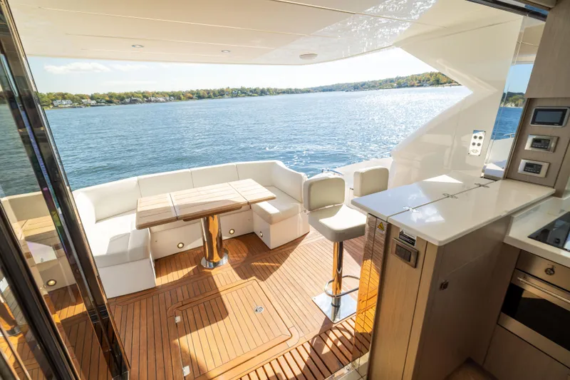 Slide: The Image of Luxurious 2018 Sunseeker Manhattan 52 yacht interior with elegant seating and scenic water view. - 60