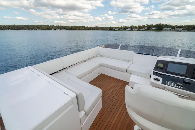Slide: The Image of Luxurious 2018 Sunseeker Manhattan 52 yacht deck with white seating and scenic water view. - 67