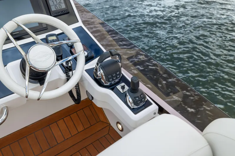 Slide: The Image of Steering wheel and controls of 2018 Sunseeker Manhattan 52 yacht on water. - 70