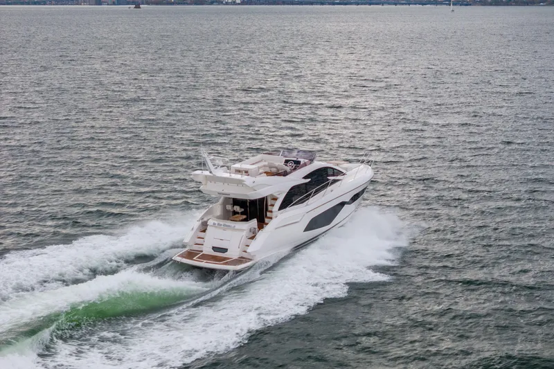 Slide: The Image of 2018 Sunseeker Manhattan 52 yacht cruising on open water. - 84