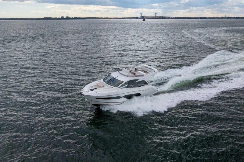 Slide: The Image of 2018 Sunseeker Manhattan 52 yacht cruising on open water. - 86