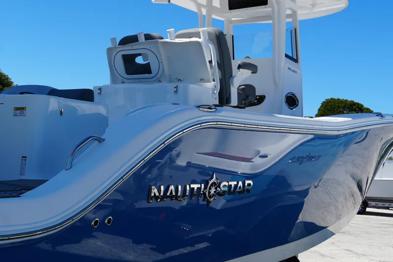 Slide: The Image of 2025 NauticStar 292 Legacy boat with sleek blue and white design. - 10