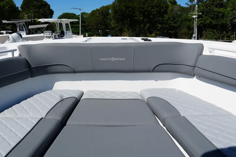Slide: The Image of 2025 NauticStar 292 Legacy boat interior with gray cushioned seating. - 13