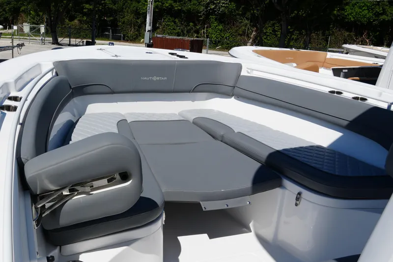 Slide: The Image of 2025 NauticStar 292 Legacy boat interior with gray cushioned seating and sleek design. - 14