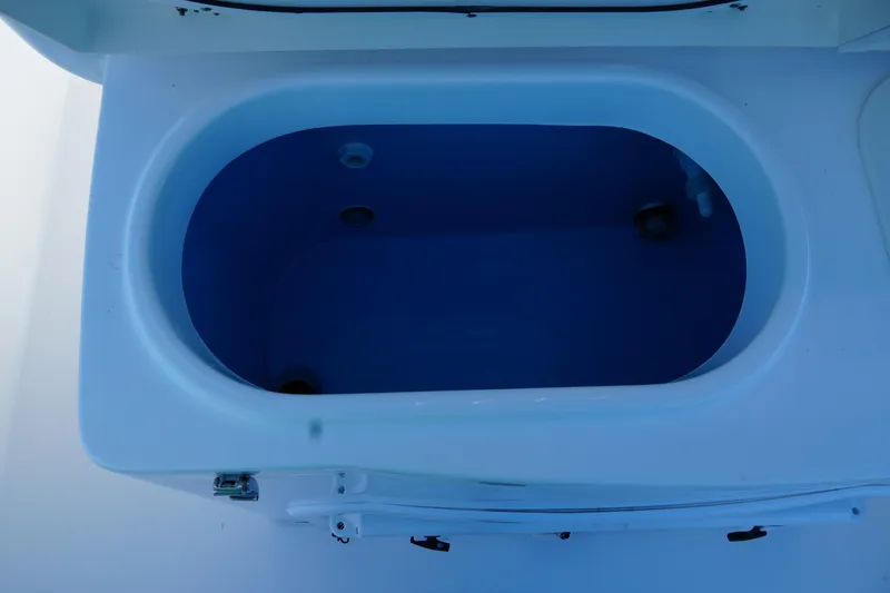 Slide: The Image of Livewell compartment on 2025 NauticStar 292 Legacy boat, open lid view. - 18