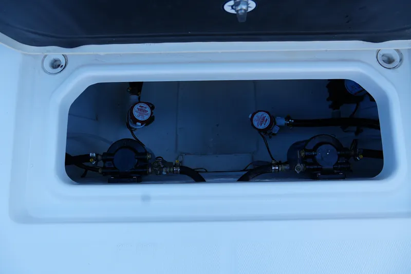 Slide: The Image of 2025 NauticStar 292 Legacy boat compartment with visible pumps and wiring. - 20
