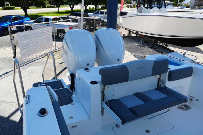 Slide: The Image of 2025 NauticStar 292 Legacy boat with dual engines and foldable seating. - 21