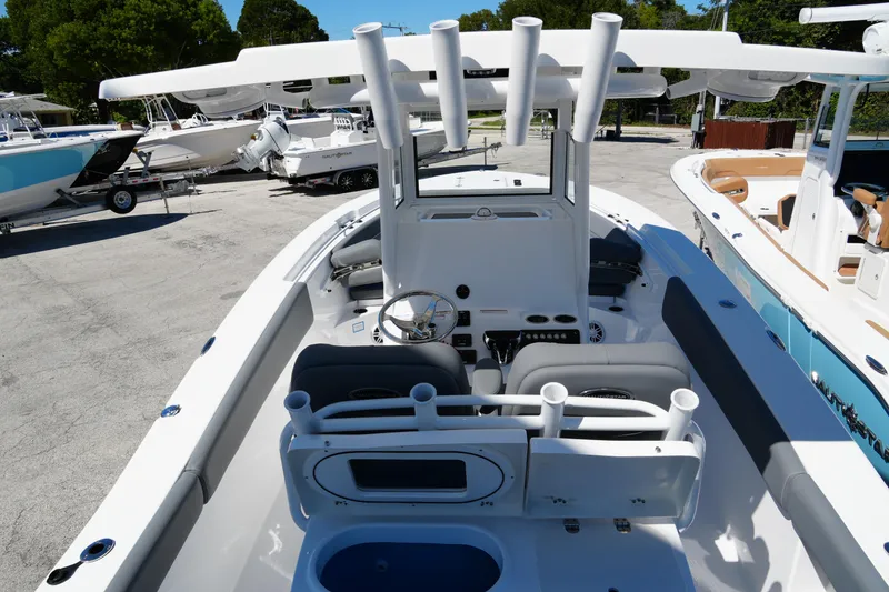 Slide: The Image of 2025 NauticStar 292 Legacy boat interior with helm, seating, and rod holders. - 22