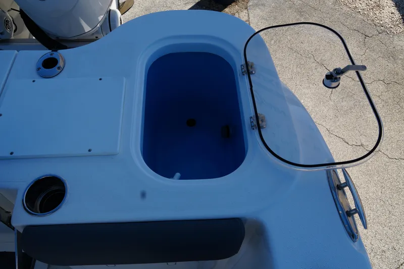 Slide: The Image of 2025 NauticStar 292 Legacy boat livewell with open lid and faucet. - 25