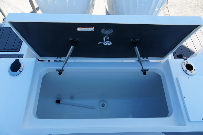 Slide: The Image of 2025 NauticStar 292 Legacy boat storage compartment with open lid and hydraulic supports. - 26