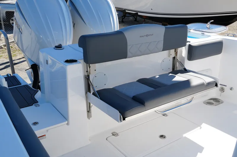 Slide: The Image of 2025 NauticStar 292 Legacy boat seating area with dual engines in the background. - 27