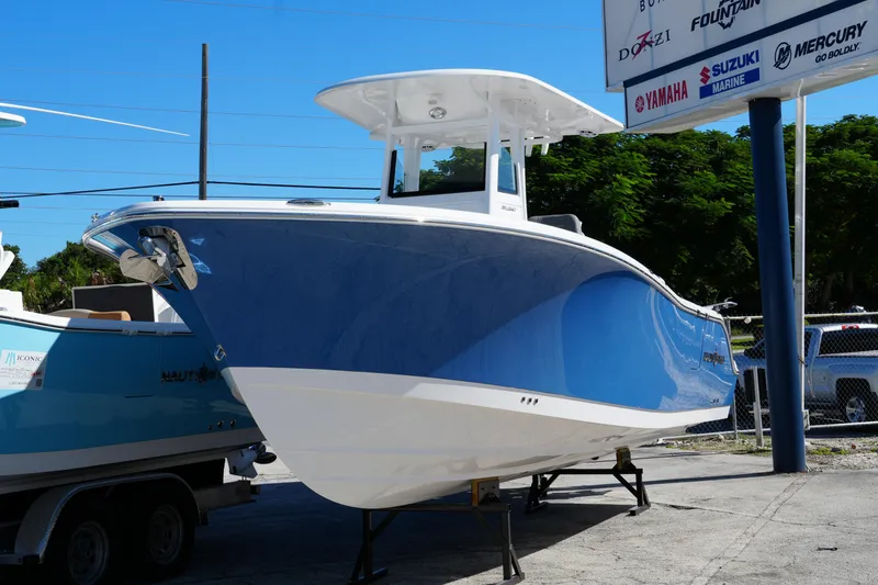 Slide: The Image of 2025 NauticStar 292 Legacy boat displayed outdoors on a sunny day. - 29