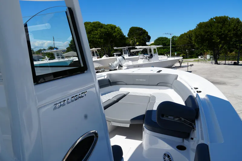 Slide: The Image of 2025 NauticStar 292 Legacy boat with spacious seating, docked under clear blue skies. - 38