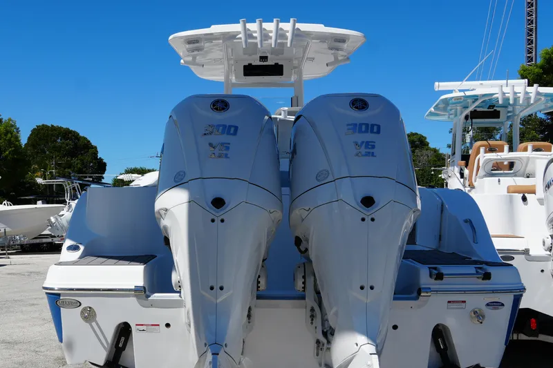 Slide: The Image of 2025 NauticStar 292 Legacy boat with dual 300 V6 engines, rear view. - 9