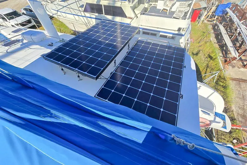 Slide: The Image of Solar panels on a 2006 Dolphin 460 yacht, with blue sail cover visible. - 19