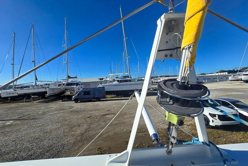 Slide: The Image of Boat yard with Dolphin 460 sailboat, 2006 model, surrounded by other vessels and vehicles. - 21