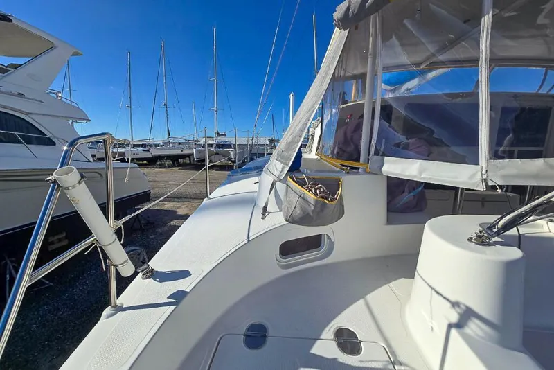 Slide: The Image of Sailboats docked at marina, featuring a 2006 Dolphin 460 catamaran in the foreground. - 30