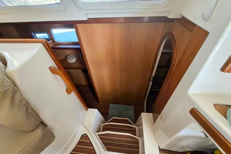 Slide: The Image of Interior view of 2006 Dolphin 460 yacht, featuring wooden stairs and cabin entrance. - 36