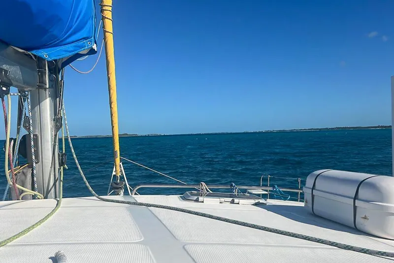 Slide: The Image of Sailing on Dolphin 460 catamaran, 2006 model, with clear blue ocean and sky. - 4