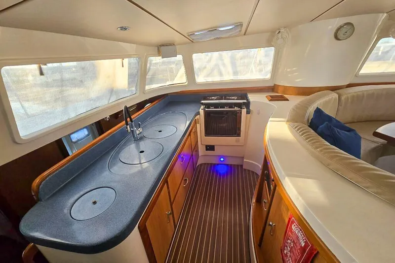 Slide: The Image of Luxurious 2006 Dolphin 460 yacht interior with modern kitchen and seating area. - 43