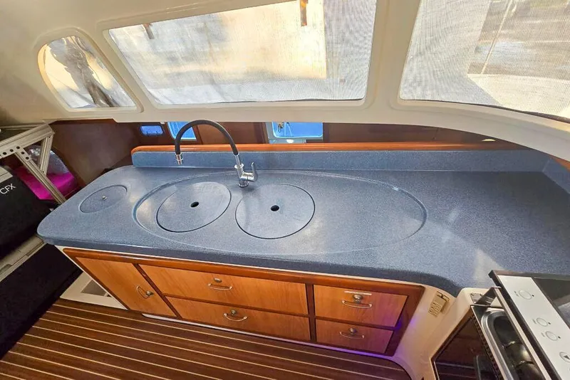 Slide: The Image of Modern kitchen in 2006 Dolphin 460 yacht with sleek countertops and wooden cabinetry. - 46