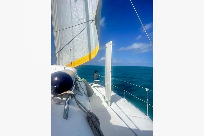 Slide: The Image of Sailing on a Dolphin 460 catamaran, 2006 model, in clear blue ocean waters. - 5