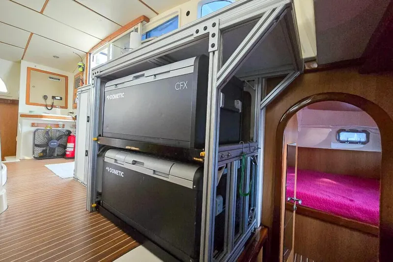 Slide: The Image of Interior of a 2006 Dolphin 460 yacht with Dometic CFX coolers and cozy cabin. - 55