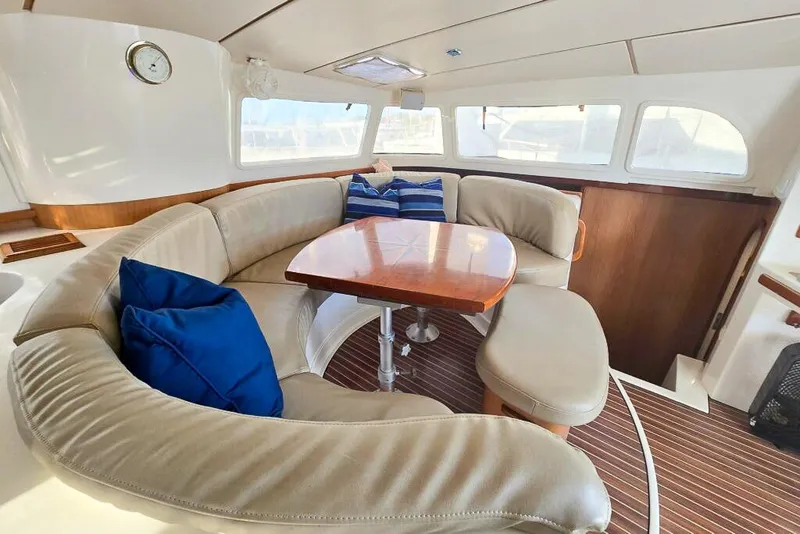 Slide: The Image of Luxurious 2006 Dolphin 460 yacht interior with plush seating and wooden table. - 56