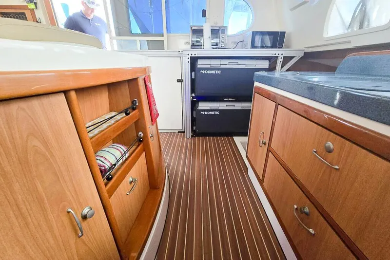 Slide: The Image of Interior of 2006 Dolphin 460 yacht with wooden cabinetry and Dometic appliances. - 57