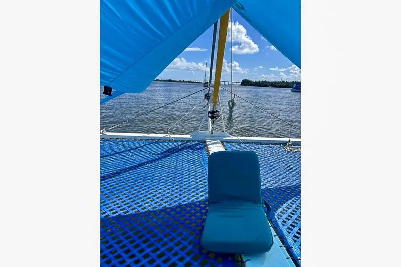 Slide: The Image of Sailboat deck view with blue netting and seat, Dolphin 460 model, 2006, on a sunny day. - 6