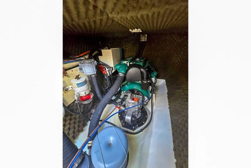 Slide: The Image of Engine compartment of a 2006 Dolphin 460, featuring various mechanical components and wiring. - 63
