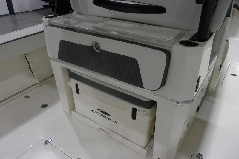 Slide: The Image of 2026 Cobia 305 Center Console boat interior with storage compartment and cooler. - 12