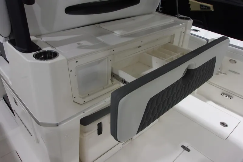 Slide: The Image of 2026 Cobia 305 Center Console boat interior with open storage compartment. - 13