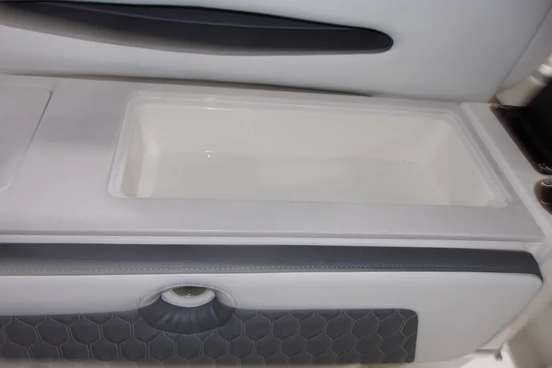 Slide: The Image of 2026 Cobia 305 Center Console interior detail with storage compartment. - 14