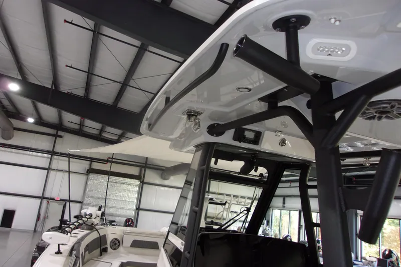 Slide: The Image of 2026 Cobia 305 Center Console boat interior in a spacious showroom. - 17