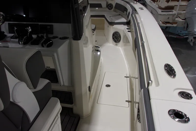 Slide: The Image of 2026 Cobia 305 Center Console boat interior with seating and control panel. - 19