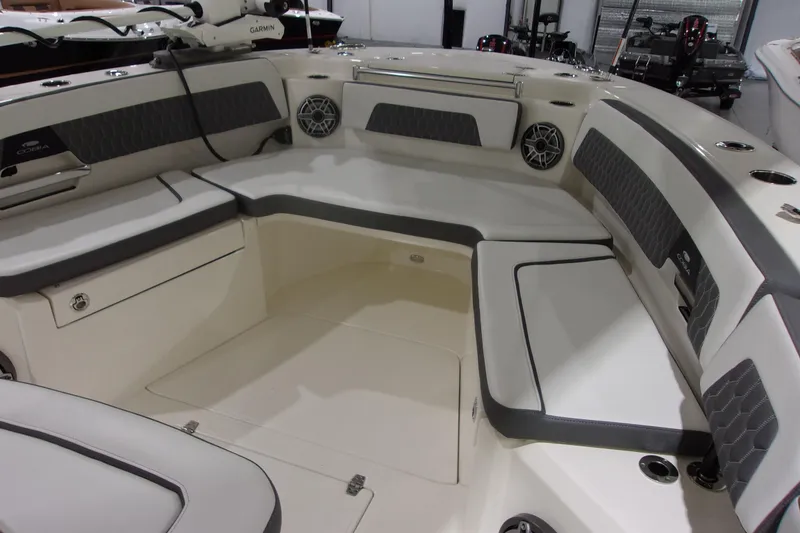 Slide: The Image of 2026 Cobia 305 Center Console boat interior with cushioned seating and speakers. - 21