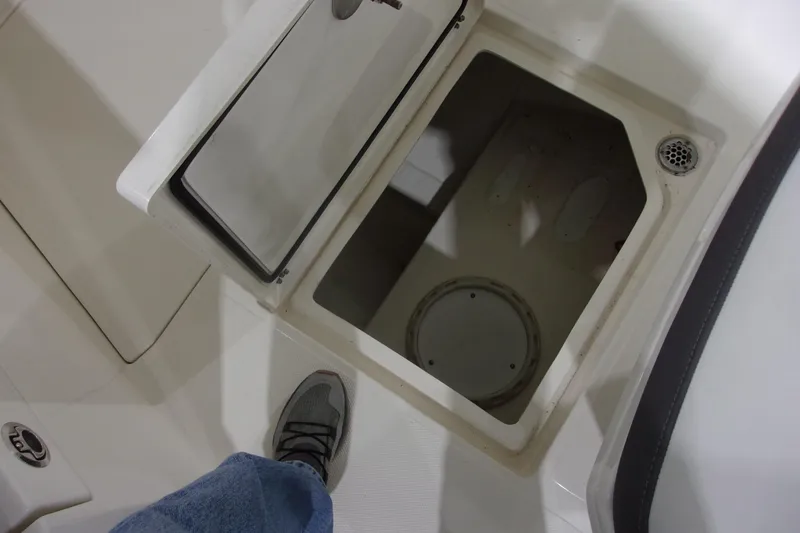 Slide: The Image of Open storage compartment on 2026 Cobia 305 Center Console boat deck. - 24
