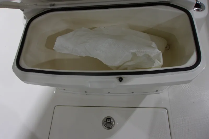Slide: The Image of Open storage compartment on 2026 Cobia 305 Center Console boat. - 25