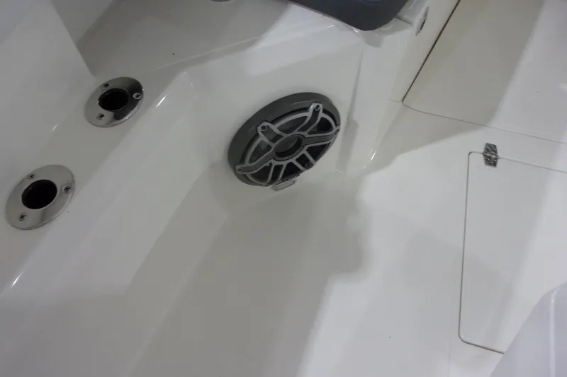 Slide: The Image of 2026 Cobia 305 Center Console boat interior with speaker and rod holders. - 28
