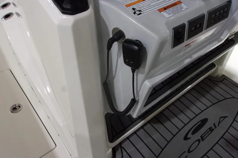 Slide: The Image of 2026 Cobia 305 Center Console boat dashboard with controls and microphone. - 6