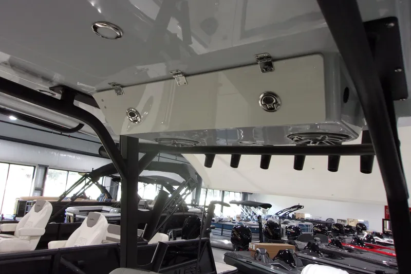 Slide: The Image of 2026 Cobia 305 Center Console boat interior with rod holders and storage compartments. - 7