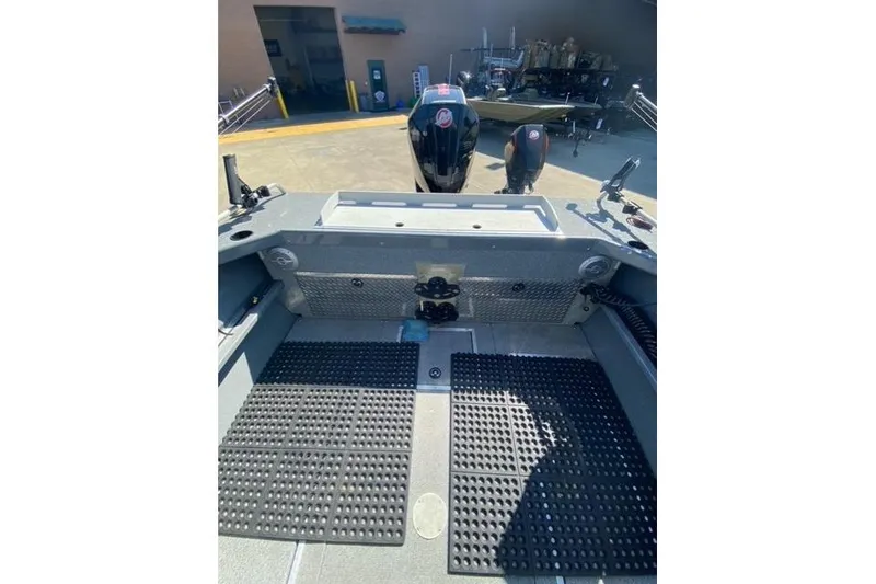 Slide: The Image of 2023 Spartan 200 Astoria boat interior with rubber flooring and motor view. - 10