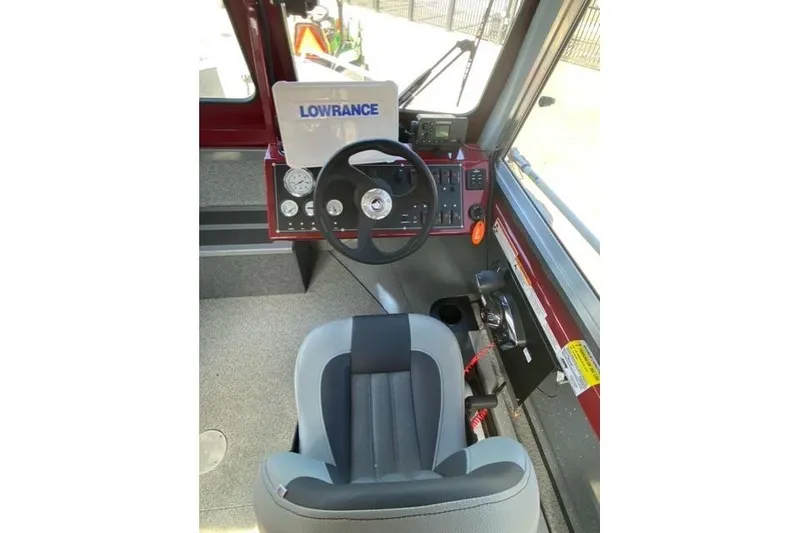 Slide: The Image of 2023 Spartan 200 Astoria boat cockpit with steering wheel and navigation equipment. - 5