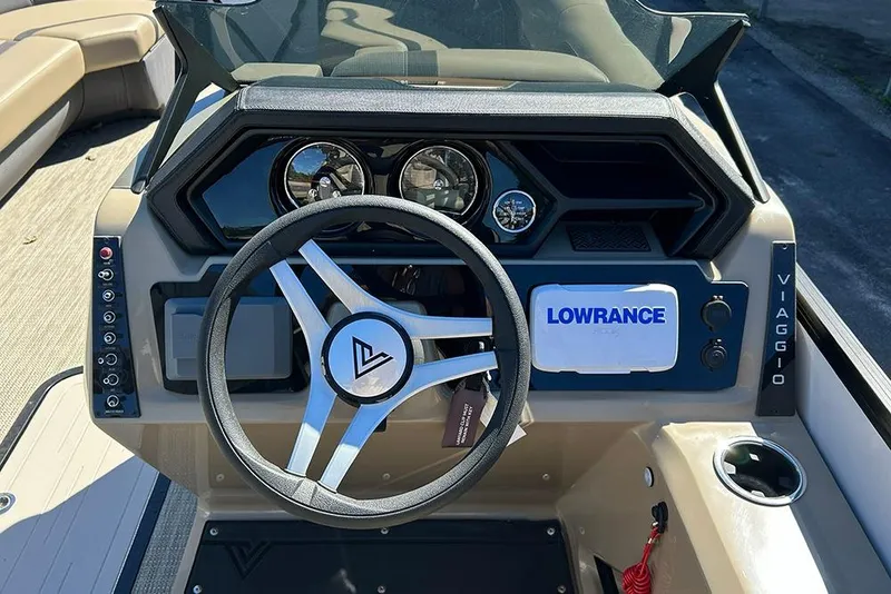 Slide: The Image of 2025 Viaggio Lago X-Q boat dashboard with steering wheel and Lowrance navigation system. - 11